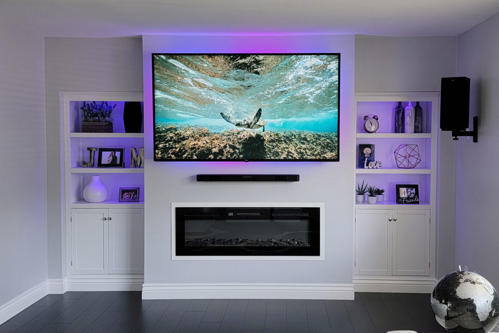 Custom media wall with TV and electric fireplace